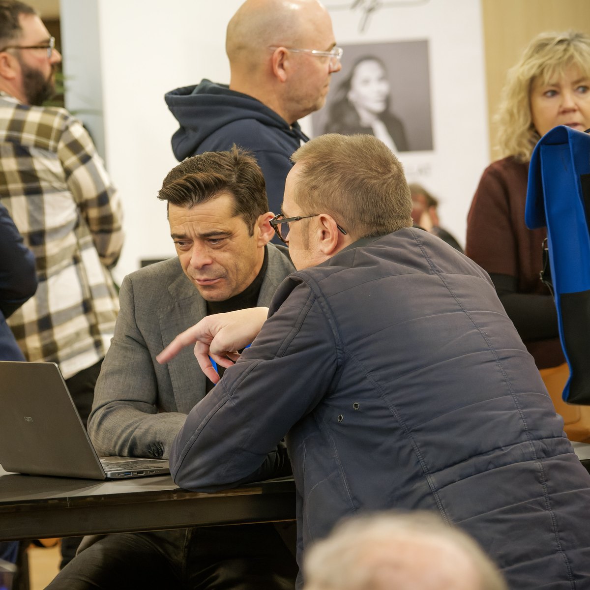 Two professionals talking over a laptop at the property fair